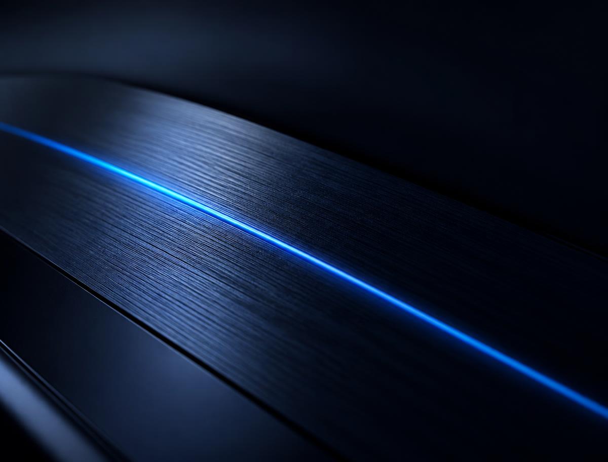 Machined dark metal surface traced by a single line of blue light